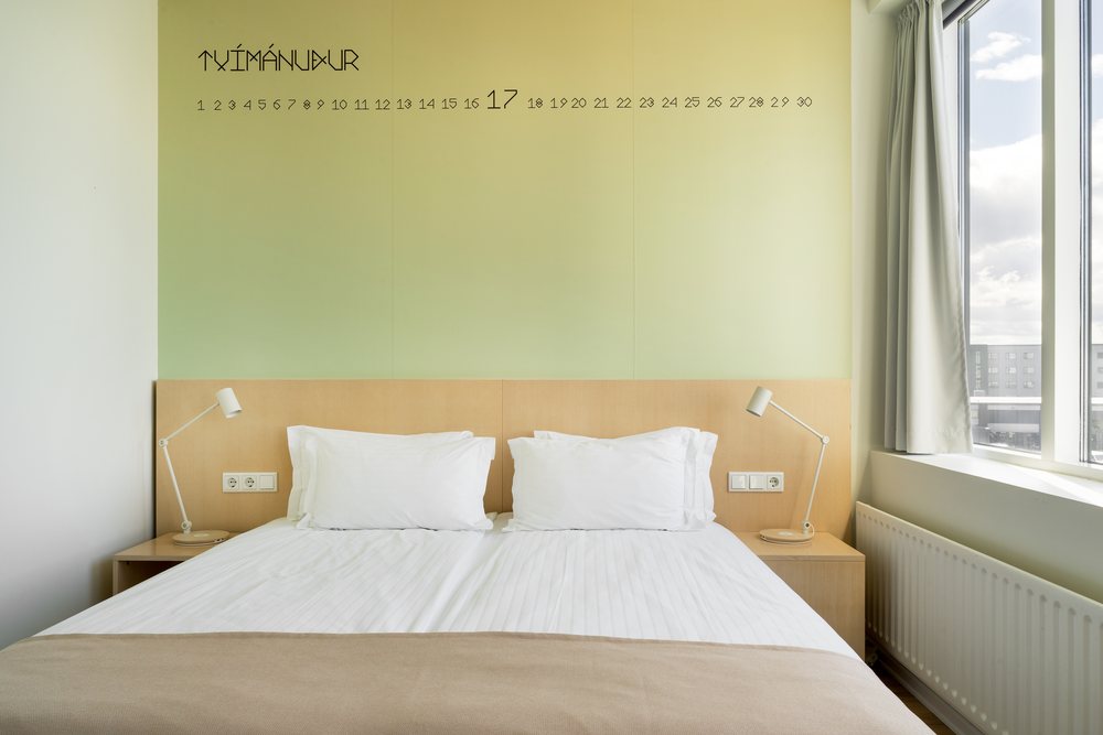 A superior double at Reykjavik Lights, its green wall lettered Tvímánuður with the days of the month in a row beneath